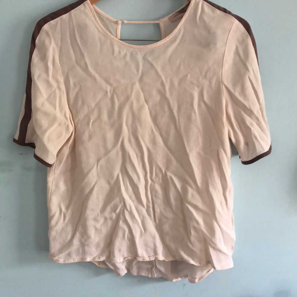white blouse with tan stripes on the arms